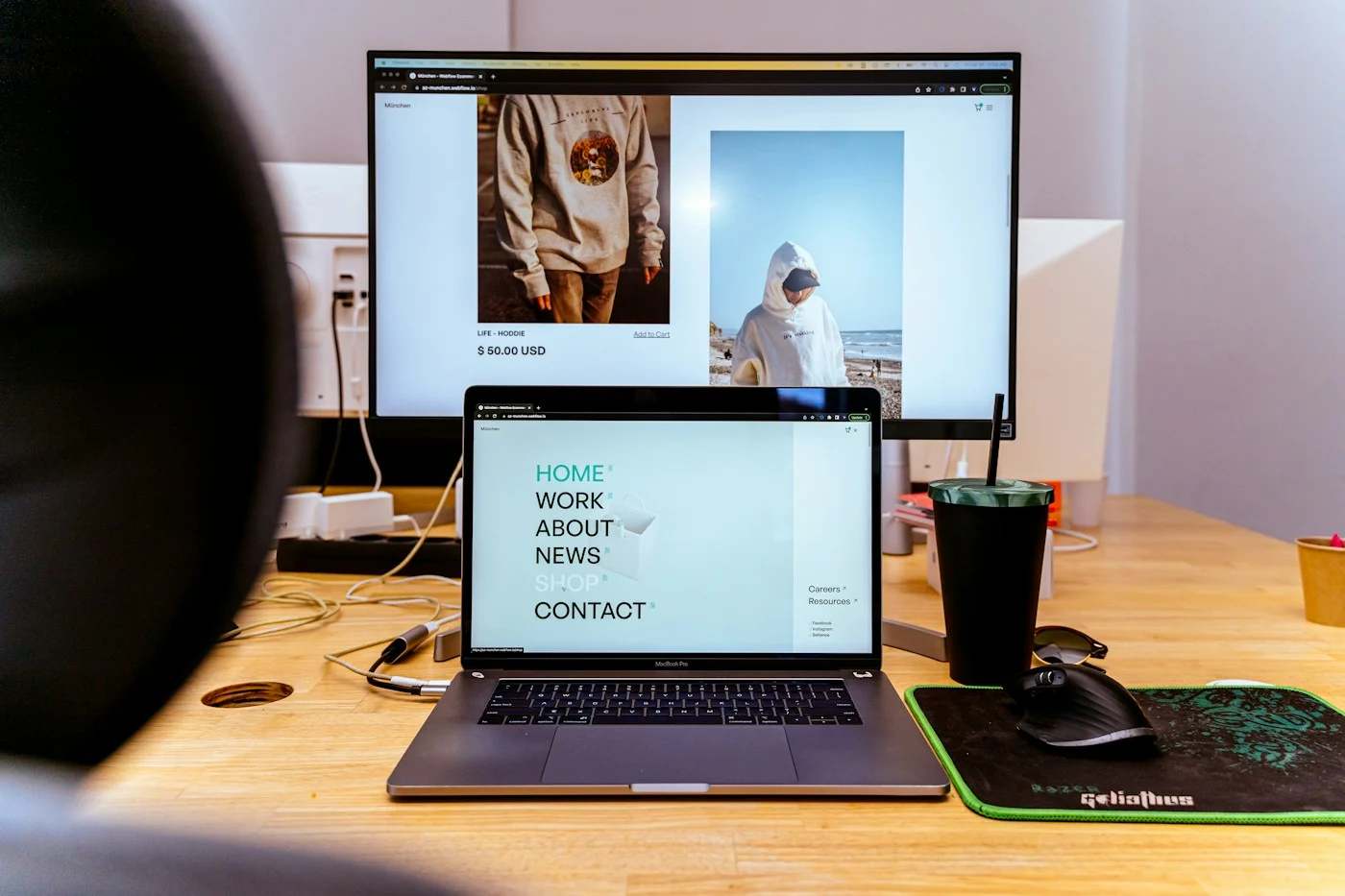 E-commerce website open on a laptop and desktop monitor